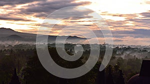 Misty forest as the sun rise, as viewed from Borobudur, a 9th century Buddhist Temple in Magelang