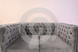 a misty gray sofa is photographed up close with the clearer texture of the sofa