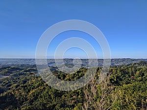 Misty hill scenery during sunrise at Puncak Songgo Langit, Mangunan, Yogyakarta photo