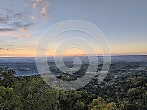 Misty hill scenery during sunrise at Puncak Songgo Langit, Mangunan, Yogyakarta photo