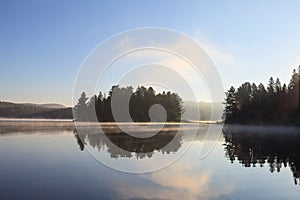 Misty lake in a summer morning