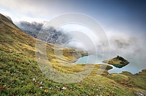 Misty morning on alpine lake Schrecksee