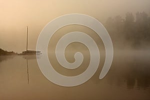 Misty morning boat at the lake