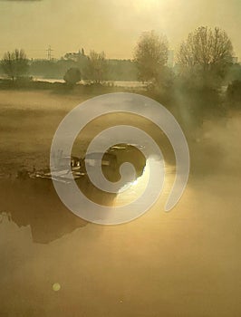 Misty morning canal barge lit by the sunshine this is London