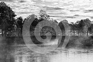 Misty morning, grayscale photography of bridge, lake and mist.