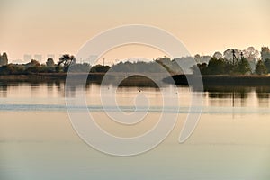 Misty morning at the lake with houses