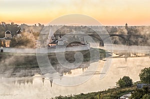 Misty morning over Volga river and monastery in Staritsa