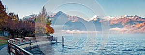 Misty morning panorama of Zell lake. Picturesque autumn view of Austrian Alps, with Grossglockner peak on background. Beauty of