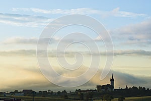 Misty morning sunrise or evening sunset over the town. Slovakia