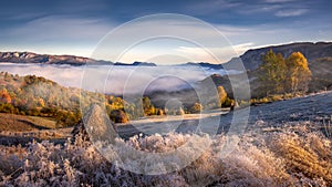 Misty morning in Transylvania with haystacks in autumn frosty morning ,country side in Romanian Mountains