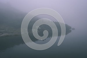 Misty morning view in wet mountain area in slovakian tatra. mountain lake panorama - vintage film look