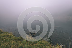 Misty morning view in wet mountain area in slovakian tatra. mountain lake panorama - vintage film look