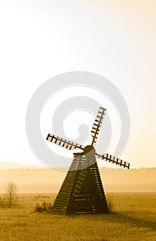 Misty morning view of the windmill on the prairie