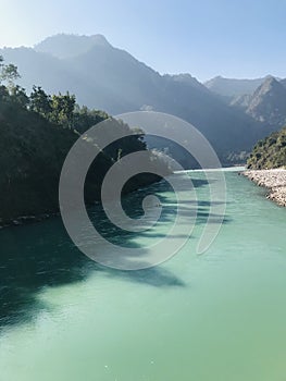 Misty morning wlecomes the day as the river Ganga flows gently murmuring between the hills photo