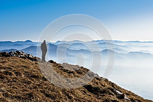 Misty mountain hills and silhouette of a man