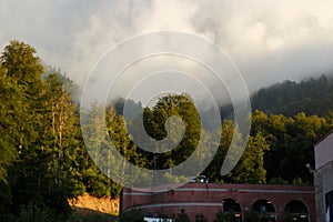 Misty mountain landscape with fir forest. Beautiful landscape with mountain view, cable car. Postcard view