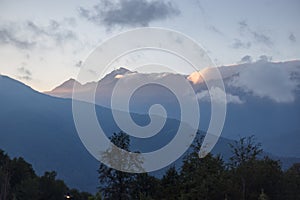 Misty mountain landscape with fir forest. Beautiful landscape with mountain view, cable car. Postcard view