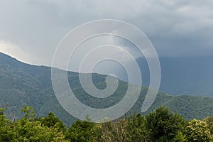 Misty mountain landscape with fir forest. Beautiful landscape with mountain view, cable car. Postcard view