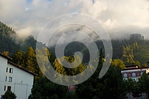 Misty mountain landscape with fir forest. Beautiful landscape with mountain view, cable car. Postcard view