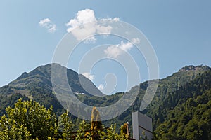 Misty mountain landscape with fir forest. Beautiful landscape with mountain view, cable car. Postcard view