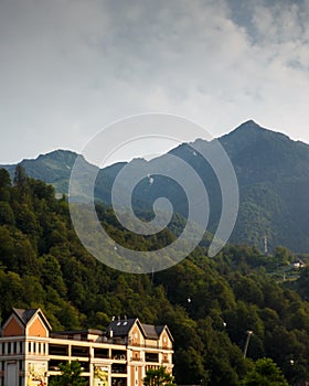 Misty mountain landscape with fir forest. Beautiful landscape with mountain view, cable car. Postcard view. Travel concept