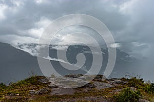 Misty mountains with dramatic cloudy sky at morning in rainy day