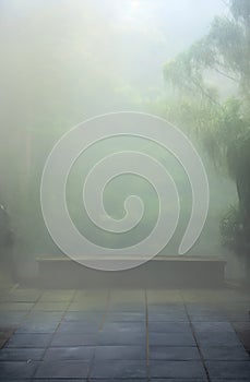 misty oriental background. foggy forest. concrete bench. peace, yoga.