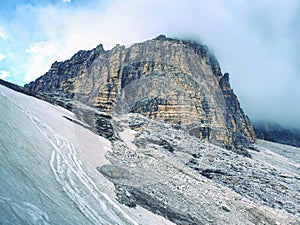 Misty peak of Sasso di Landro, massive Tre Cime di Lavaredo rocks,