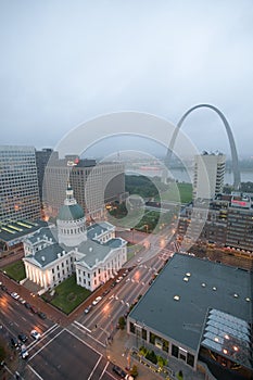 In a misty rain an elevated view of Gateway Arch and the historical Old St. Louis Courthouse. The Courthouse was constructed of b