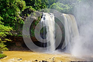 Misty rocky waterfall captured high angle.