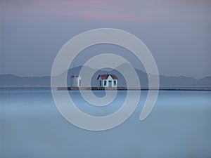 Misty Sea, Pier and Mountains photo