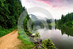 Misty sunrise with clouds on the Red Lake Romania