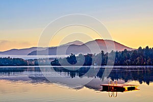 Misty sunrise morning Mirror Lake Lake Placid NY