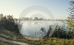 Misty sunrise over a lake summer morning