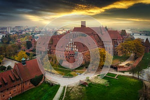 Misty sunrise over the Malbork castle and Nogat river in Poland