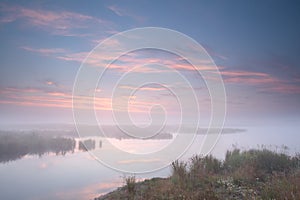 Misty sunrise over river