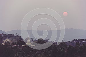 Misty Thailand countryside morning with a temple in the distance