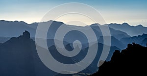 Misty view of mountain layer silhouettes at Caldera de Tejeda, Degollada de las Palomas, Gran Canaria Island, Spain photo