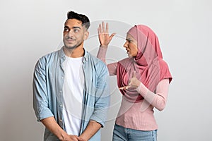 Misunderstanding In Relations. Young Muslim Couple Arguing, Woman In Hijab Blaming Husband