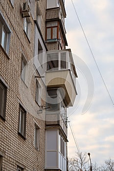 Misunderstood balconies on the wall of the apartments. Different in shape, size, material and construction balconies one above the