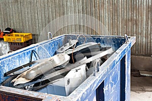 Mitallic container full of industrial iron waste products.