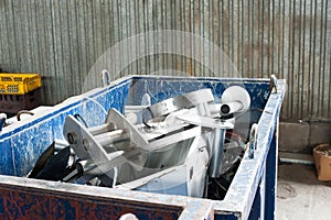 Mitallic container full of industrial iron waste products.