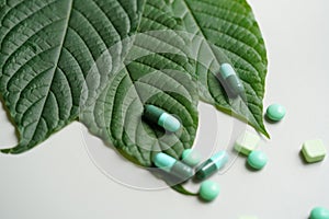 Mitragyna speciosa drug plant with pills in the laboratory resea