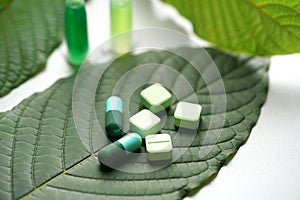 Mitragyna speciosa korth kratom drug plant with pills in labor