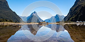 Mitre Peak reflecting on water surface in Milford Sound - Piopiotahi, Fiordland, Nez Zealand