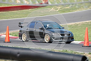 Mitsubishi Evolution Sedan driving on Race Course