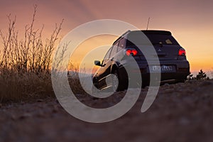 Mitsubishi outlander turbo in mountain road during sunset