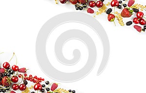 Mix berries and fruits at border of image with copy space for text. Ripe cherries, strawberries, currants and mulberrieson white b