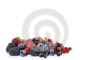 Mix berries and fruits isolated on a white. Ripe blueberries, blackberries, currants and strawberries. Berries and fruits with cop
