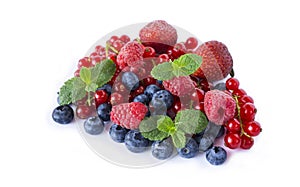 Mix berries and isolated on a white. Ripe blueberries, raspberries, red currants and strawberries with mint. Berries and fruits wi